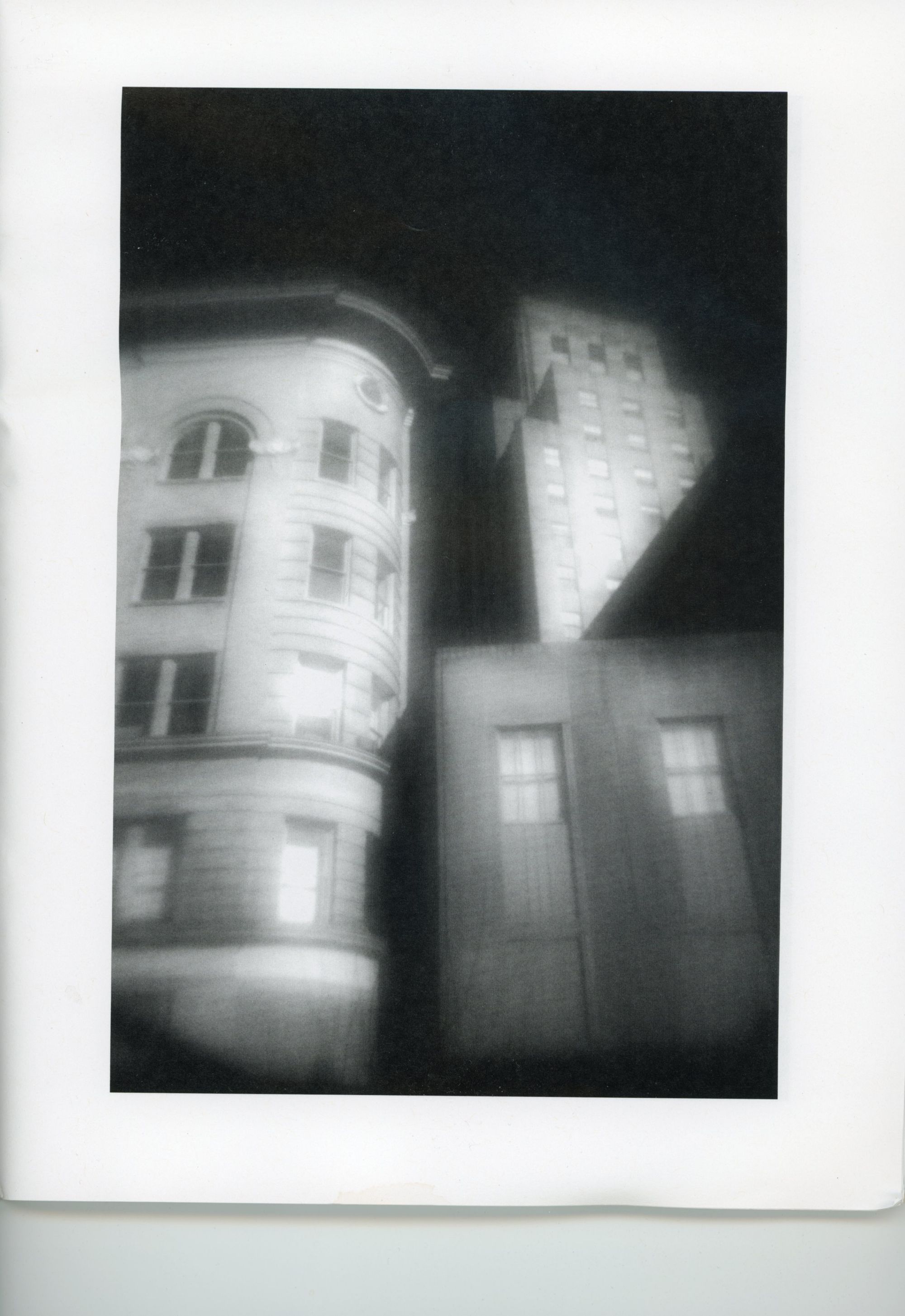 This is a haunting, somewhat ethereal photo of several old, brick buildings in black and white. Infrared maybe. From Chuck Cunningham's No Context zine, #6